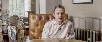A portrait image of the general manager in the seating area at the Dog and Partridge.