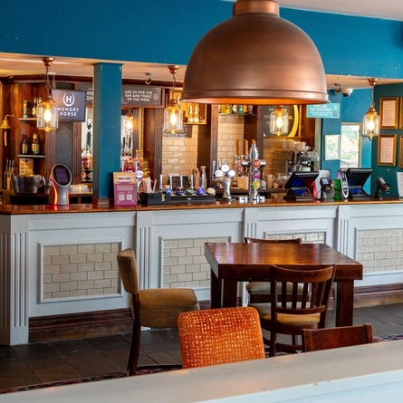 Interior dining area of a pub with a bar.