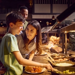 A family choosing a selection of foods for a carvery at the carvery deck.