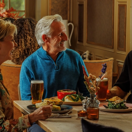 An image of 3 people enjoying Pie Choice Mains and drinks within the interior restaurant seating area at The Foundry Bell.