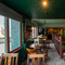 An interior restaurant seating area at The Junction, with TVs and framed artwork on the walls.