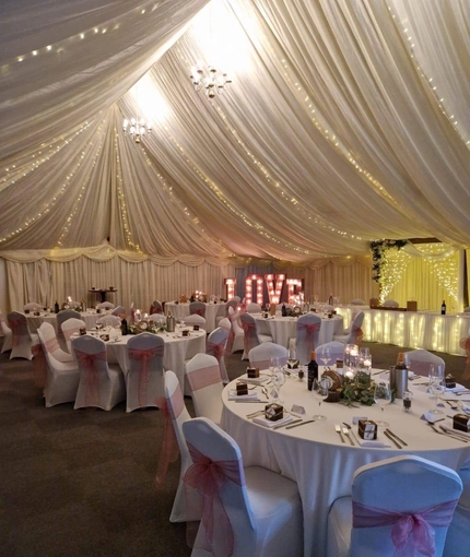 A marquee, decorated for a wedding.
