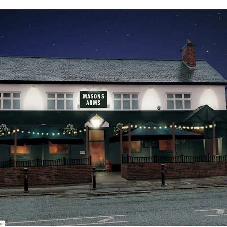 An image featuring the exterior facade with floral hanging baskets at The Masons Arms.
