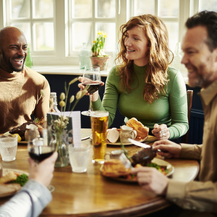 A group of people enjoying a roast dinner.
