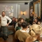 An image of people sat at tables clapping as a person in a traditional Scottish outfit dances within the interior function room during a Burns Night Event at The Crabtree.