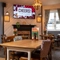 The interior restaurant and seating area with TV at The Woodlands.