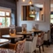 An interior restaurant seating area at The Wall's End, with upholstered chairs and booth seating.