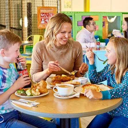 A family eating a meal at Wacky Warehouse
