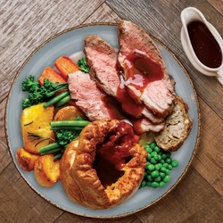 A beef roast dinner and a jug of gravy.