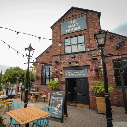 External view of a pub entrance and beer garden
