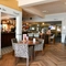 Interior dining area of a pub with a bar and a TV.