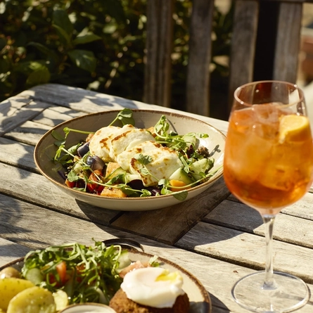 An image showing the salmon and mature cheddar fishcake and roasted vegetable and grain salad with butternut squash at Chef & Brewer.