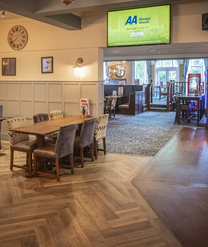 Interior dining area of a pub with a TV.