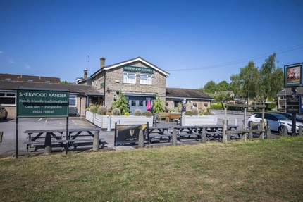 An exterior shot of the car park, facade & seating area at the Sherwood Ranger in Ravenshead.