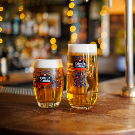 A pint and half a pint of Estrella Galicia sat on the interior bar.