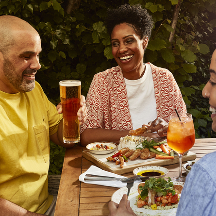 Guests enjoying food and drink in a Chef and Brewer beer garden