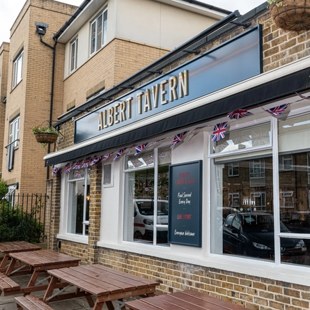 An image showing the exterior facade of the venue with outdoor seating at The Albert Tavern.