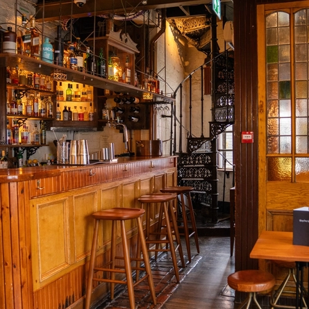 The interior bar with bar stools and seating area at the Ubiquitous Chip.