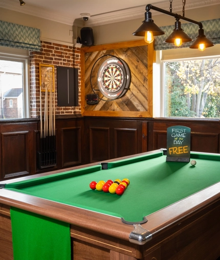 The interior pub gaming area at The Longship in Hebburn, with a dartboard and a pool table.