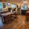High seats in a bar area with a bar. The room is decorated for Christmas