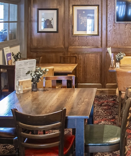 The interior restaurant seating area and TV at The Bull.