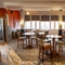 Interior dining area of a pub with a bar and a TV.