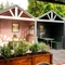 Three sheltered booth seating areas in the beer garden of The Talbot, with padded bench seats.