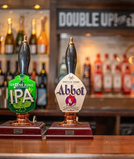 A close up image of various pumps at the interior bar at The Old Red Lion.
