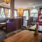 Interior dining area of a pub with a claw machine.