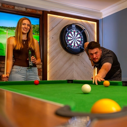 An image of 2 people playing pool within the interior of a Hungry Horse venue.