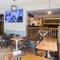 Interior dining area of a pub with a TV.