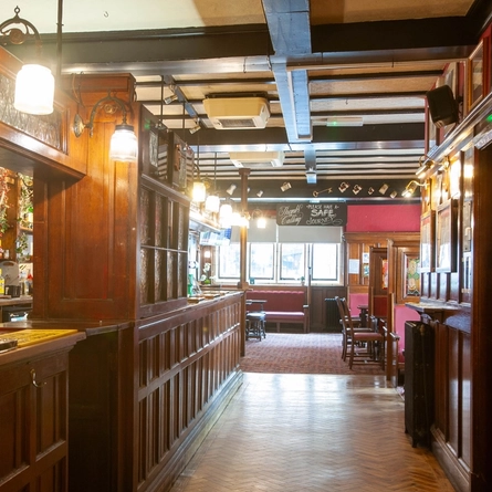 Interior dining area and bar area of a pub.