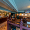 The wood panelled bar, and interior restaurant seating area at The Junction, with a TV on the wall.