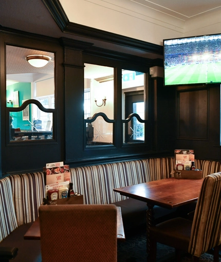 interior dining area of a pub with a TV