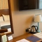 An image showing the interior of one of the hotel rooms featuring bed, dressing table with mirror, hot drinks making facilities and wall mounted TV at The Antelope.
