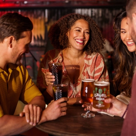 An interior shot of a group of people with various drinks during the Q3 Live Music Event at one of the Greene King Pubs.