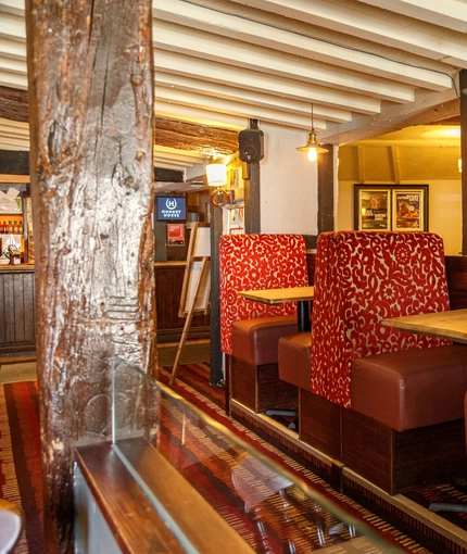 Interior dining area of a pub with a TV.