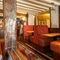 Interior dining area of a pub with a TV.