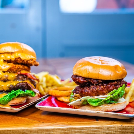A couple of burgers on plates.