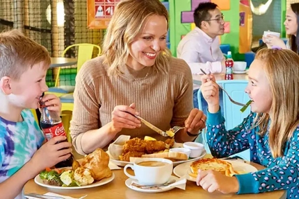 A family eating a meal at Wacky Warehouse