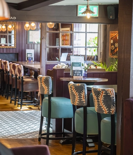 The interior restaurant and seating area with log burner at The Bell.
