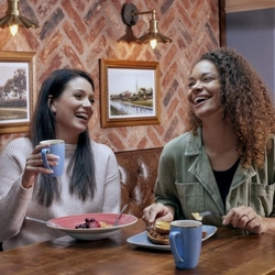 Two people enjoying breakfast at a Hungry Horse.