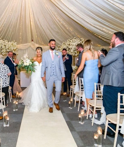 A bride and groom walking down the aisle.