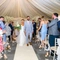 A bride and groom walking down the aisle.