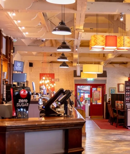 The interior restaurant and seating area with bar in the Kingstown Hotel.