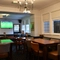 interior dining area of a pub with a TV and a dartboard