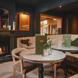 The seating area and a fireplace in The Prince Of Wales.
