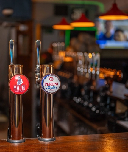 A close up image of various pumps at the interior bar at The Old Red Lion.