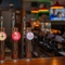 A close up image of various pumps at the interior bar at The Old Red Lion.