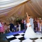A bridge and groom dancing in a marquee.
